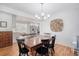 Charming dining room features a wooden table, stylish light fixture, and seamless transition to the updated kitchen at 101 Plantation Dr, Summerville, SC 29485