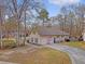 Charming home featuring a long driveway, mature trees, and an American flag at 101 Plantation Dr, Summerville, SC 29485