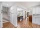 Spacious home interior features hardwood floors, a staircase, and an open floor plan connecting dining and living areas at 101 Plantation Dr, Summerville, SC 29485