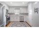 Modern kitchen with white cabinetry, stainless steel appliances, gray backsplash, and ample countertop space at 101 Plantation Dr, Summerville, SC 29485