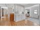Open kitchen area with white cabinets, tile backsplash, and seamless access to other rooms in the home at 101 Plantation Dr, Summerville, SC 29485