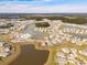 Expansive aerial view of a planned community featuring numerous homes, a pool, and a series of interconnected ponds at 109 Airy Dr, Summerville, SC 29486