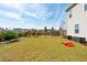 Large green backyard with rocking chairs, storage units, and recreational equipment at 109 Airy Dr, Summerville, SC 29486