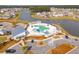 Overhead view of a community pool complex with umbrellas, cabanas, a clubhouse, and lakeside access at 109 Airy Dr, Summerville, SC 29486