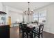 Sunlit dining room with a chandelier, large window, and set table on hardwood floors, perfect for gatherings at 109 Airy Dr, Summerville, SC 29486