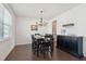 Traditional dining room with black table set and chandelier, complemented by dark hardwood floors and a stylish buffet at 109 Airy Dr, Summerville, SC 29486