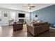 Cozy living room with fireplace, a blue accent wall, hardwood floors, and comfortable seating for relaxation at 109 Airy Dr, Summerville, SC 29486