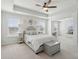 Bright main bedroom features tray ceilings, white bedding, and a comfortable sitting area at 109 Airy Dr, Summerville, SC 29486