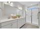 Bright bathroom featuring double vanity with white countertops and a glass-enclosed shower with white subway tile at 110 Brown Swiss Cir, Summerville, SC 29483