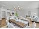 Open-concept living space features a dining area with a wooden table, white chairs, and modern chandelier at 110 Brown Swiss Cir, Summerville, SC 29483