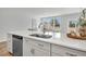 Kitchen island featuring a stainless sink and views to the fenced-in backyard at 110 Brown Swiss Cir, Summerville, SC 29483