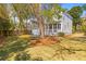 Spacious backyard with lush lawn, wooden fence, mature trees, and charming swing at 1100 Sea Island Crossing Ln, Mount Pleasant, SC 29464