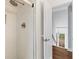 Walk-in shower featuring decorative patterned tile walls, rainfall shower head, and glass door at 1100 Sea Island Crossing Ln, Mount Pleasant, SC 29464