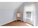 Well-lit bedroom space with an easel by a window, hardwood floors, and neutral decor at 1100 Sea Island Crossing Ln, Mount Pleasant, SC 29464