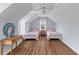 Charming bedroom featuring hardwood floors, twin beds, and natural light from a large window at 1100 Sea Island Crossing Ln, Mount Pleasant, SC 29464