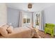 Bright bedroom with hardwood floors, neutral walls, and a comfortable bed near sunlit windows at 1100 Sea Island Crossing Ln, Mount Pleasant, SC 29464