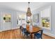 Dining room offers hardwood floors, natural light, and a cozy chandelier at 1100 Sea Island Crossing Ln, Mount Pleasant, SC 29464