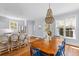 Charming dining area features hardwood floors, bright windows, and stylish chandelier at 1100 Sea Island Crossing Ln, Mount Pleasant, SC 29464