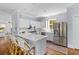 Bright kitchen features stainless appliances, island with seating, and white cabinetry at 1100 Sea Island Crossing Ln, Mount Pleasant, SC 29464