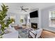 Bright and airy living room with a fireplace, neutral furniture, and hardwood floors at 1100 Sea Island Crossing Ln, Mount Pleasant, SC 29464