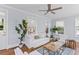 Inviting living room with a cozy sofa, light-filled windows, and a modern ceiling fan at 1100 Sea Island Crossing Ln, Mount Pleasant, SC 29464