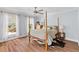 Serene main bedroom with four-poster bed, ceiling fan, and light-filled windows at 1100 Sea Island Crossing Ln, Mount Pleasant, SC 29464