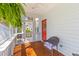 Charming porch with wicker chair and a bright red door. Perfect for enjoying the outdoors at 1100 Sea Island Crossing Ln, Mount Pleasant, SC 29464