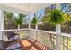 Relaxing screened-in porch with wicker furniture and lush green outdoor views at 1100 Sea Island Crossing Ln, Mount Pleasant, SC 29464