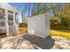 Charming backyard shed with paved patio and partial view of screened in porch at 1100 Sea Island Crossing Ln, Mount Pleasant, SC 29464