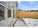Back patio with sliding glass door, vinyl siding, small yard with wood fence and snow at 112 Brown Swiss Cir, Summerville, SC 29483