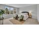 Serene bedroom with large windows, neutral decor, and cozy seating area at 112 Brown Swiss Cir, Summerville, SC 29483