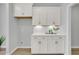 Elegant dry bar area with white cabinets, quartz countertops, and stylish decor at 112 Brown Swiss Cir, Summerville, SC 29483