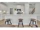 Bright kitchen with a spacious island, modern lighting, and bar stool seating at 112 Brown Swiss Cir, Summerville, SC 29483