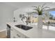 Modern kitchen island with a stainless steel sink and view into the dining and living spaces at 112 Brown Swiss Cir, Summerville, SC 29483