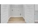Open laundry room with wood-look floor, washer/dryer hookups, and bi-fold closet doors at 112 Brown Swiss Cir, Summerville, SC 29483