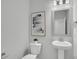 Clean powder room with a pedestal sink, modern art, and a neutral color scheme at 112 Brown Swiss Cir, Summerville, SC 29483