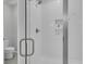 Modern walk-in shower featuring white subway tile, glass door, and built-in shelving at 112 Brown Swiss Cir, Summerville, SC 29483