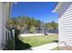 Spacious backyard features a basketball court, gazebo, and lush greenery, perfect for outdoor activities at 112 Carpenter St, Summerville, SC 29486