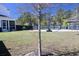 Expansive backyard with a basketball court, gazebo, lush lawn, and plenty of room to relax at 112 Carpenter St, Summerville, SC 29486
