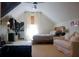 Cozy bedroom with sloped ceilings, a comfortable bed, a sofa, and stylish decor elements at 112 Carpenter St, Summerville, SC 29486