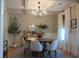 Elegant dining room with coffered ceilings, stylish chandelier, and large windows providing ample natural light at 112 Carpenter St, Summerville, SC 29486