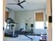 Bright exercise room with a ceiling fan, treadmill, bench with weights, and a wall mirror at 112 Carpenter St, Summerville, SC 29486