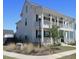 Stately two-story home boasts double balconies, elegant black shutters, and pristine landscaping at 112 Carpenter St, Summerville, SC 29486