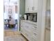 Elegant kitchen with white cabinetry and brass hardware, open to the dining area at 112 Carpenter St, Summerville, SC 29486