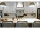 Spacious kitchen island with white countertop, stylish lighting, and seating for four at 112 Carpenter St, Summerville, SC 29486