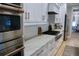 Modern kitchen with stainless steel appliances, white cabinets, quartz countertops, and tile backsplash at 112 Carpenter St, Summerville, SC 29486