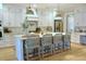 Bright kitchen features a large island, white cabinetry, stylish lighting, and hardwood floors at 112 Carpenter St, Summerville, SC 29486