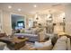 Open-concept living room flows into the kitchen with a cozy sofa and lots of natural light at 112 Carpenter St, Summerville, SC 29486