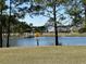 Serene pond surrounded by lush greenery, providing a peaceful view for neighborhood residents at 112 Carpenter St, Summerville, SC 29486