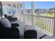 Covered porch with cushioned seating offers a serene outdoor living space and neighborhood views at 112 Carpenter St, Summerville, SC 29486